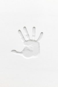 The imprint of a hand in a white material