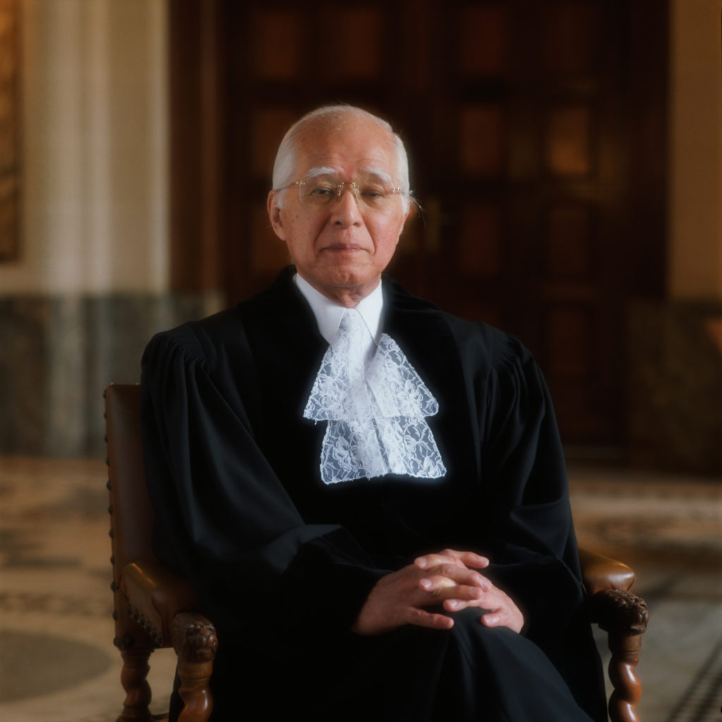 Judge Hisashi Owada is pictured sitting in a chair, wearing his formal robes.